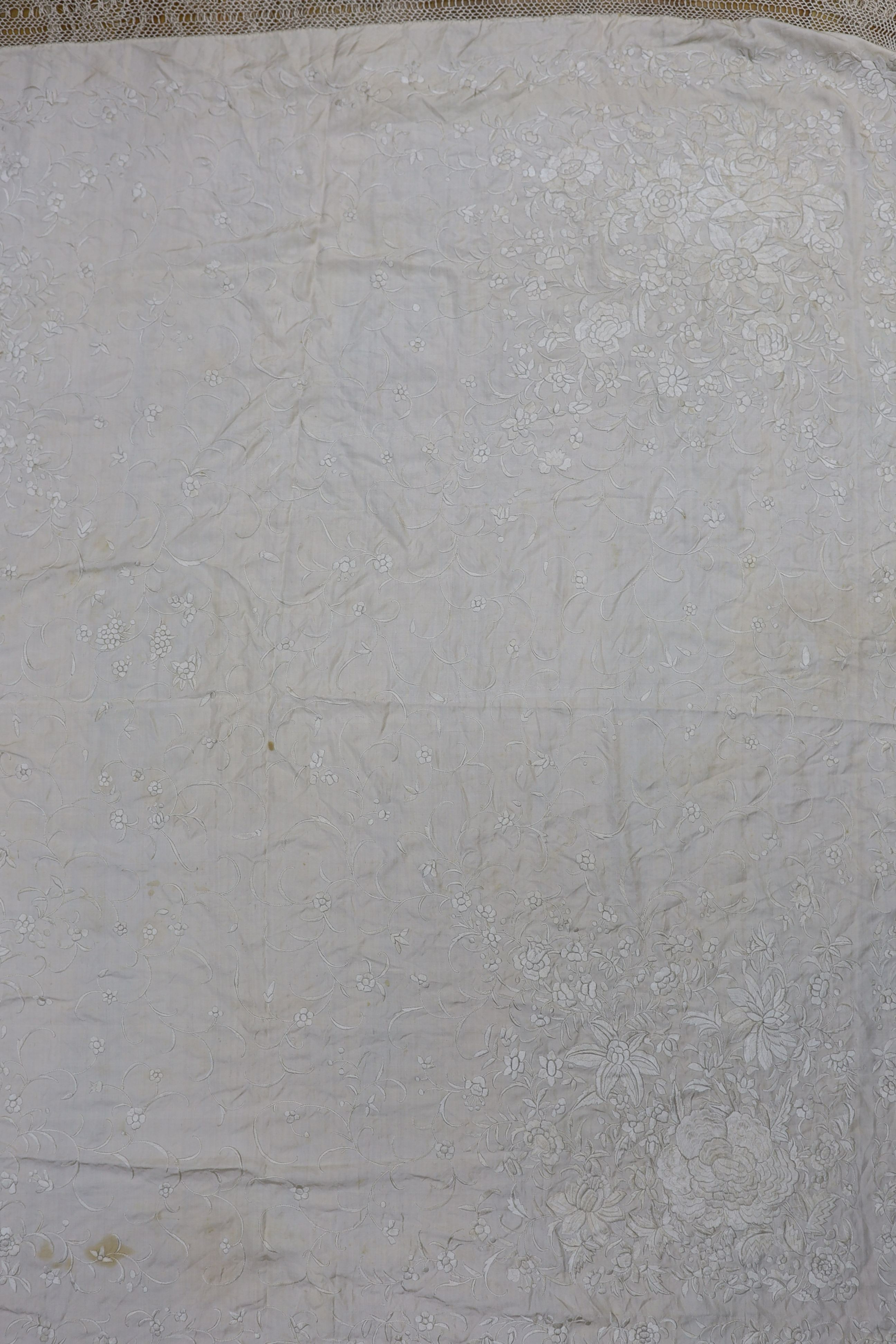 A 19th century cream embroidery on cream silk shawl together with a smaller later shawl